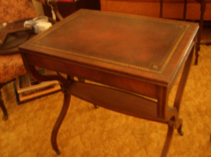 Top view of French table showing leather top and stretcher forming an oval shelf 