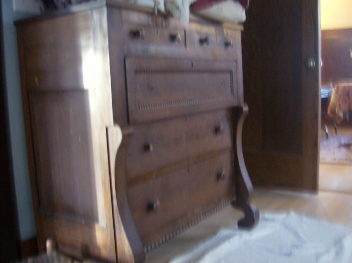 Antique  veneer chest w/ top overhang drawer and curved columns at sides. 