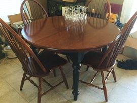 beautiful farm table with black legs-- 1 leaf to expand to an oval shape- 4 ladder-back chairs