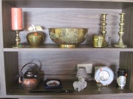 Lots of decorative items that include brass, bronze, porcelain and potter