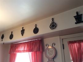 some of many antique and vintage trivets