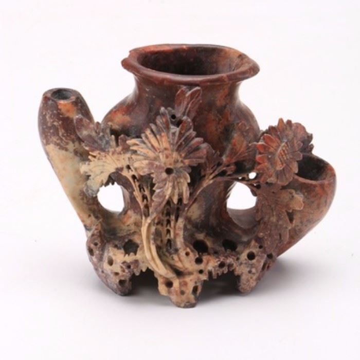 Chinese Soapstone Vase: A Chinese carved soapstone vase. The piece features a rim to the top and an ornate natural design throughout. The piece is not marked.