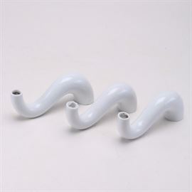 Rosenthal Candle Holders: An assortment of Rosenthal candle holders. This lot of three porcelain holders are moulded in a distinctive curve that is flush with the surface it sits on. The end is hollowed with a hole to hold a candle.