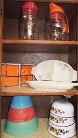 Over-full kitchen with many new and new in box items. All basic items including: solid white dish set, several pot and pan sets, drinkware, utensils old and new, knives and knive sets (Cutco), storage containers, entertaining items, cooking and baking.