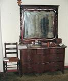 ANTIQUE MID VICTORIAN FLAME MAHOGANY SERPENTINE TRIPLE DRESSER WITH ORNATE CARVED MIRROR AND RED MARBLE TOP AND ANTIQUE LADDER BACK CHAIR