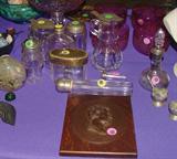 ANTIQUE CAST ABE LINCOLN PLAQUE AND ASSORTED ANTIQUE GLASS AND SILVERPLATE BOTTLES AND CONTAINERS