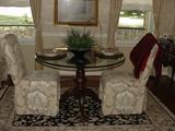 HEAVY CARVED WOOD PEDESTAL GLASS TOP TABLE WITH UPHOLSTERED CHAIRS IN TAUPEY TOILE FABRIC