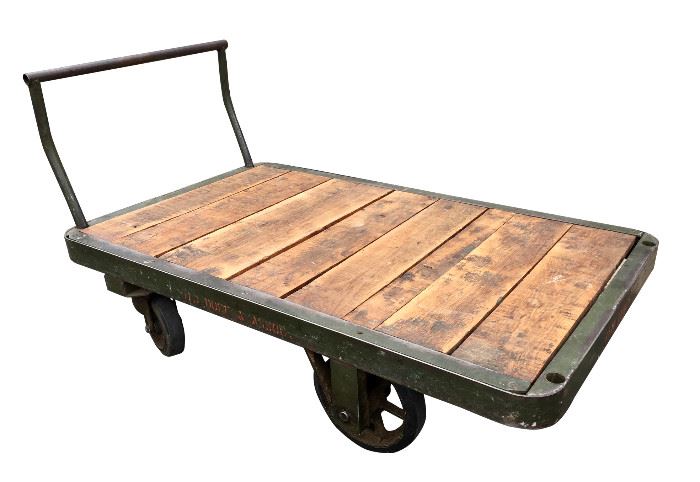 Very large industrial cart with wooden top and heavy wheels. Perfect for your industrial decor or as functional tool! Could be made into a coffee table! This cart is large and very very heavy!!! You will need help to load and a large enough vehicle. Will not fit in a Toyota Prius. Measures approximately 