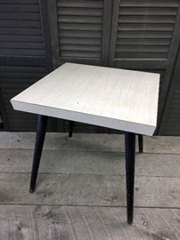 Mid century modern, Eames Era, side table with grayish weathered wood type Formica top and Black charcoal colored wooden hairpin style legs. Measures approx 21 x 21 inches.