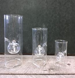 Lot of three Wolfard Oil Lamps that are hand-blown from borosilicate glass (known for its strength and clarity) using an exclusive "in-flame" glassblowing technique which requires higher temperatures than other art glass methods. Oil lamp measurements 6 inch 9 inch and 12 inch.