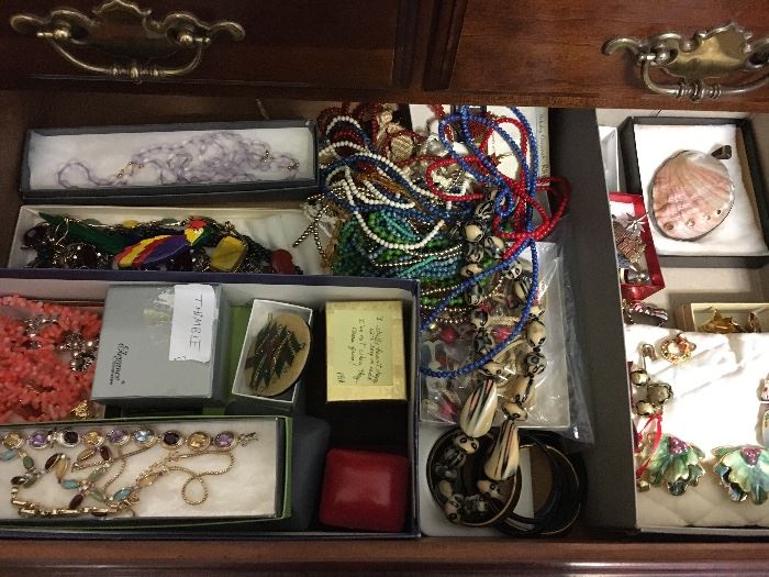 Packed table full of costume jewelry.