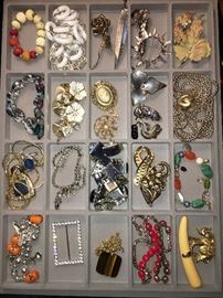 Packed table full of costume jewelry.