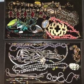 Packed table full of costume jewelry.