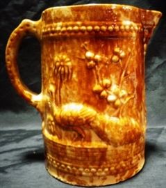 Stoneware pitcher with peacock relief