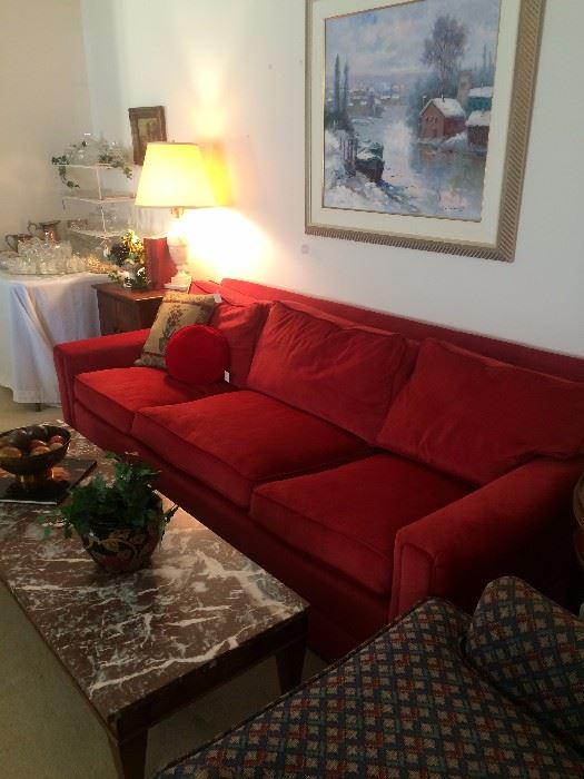Three-cushioned red sofa; long marble-top coffee table