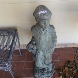 Boy golfer statue