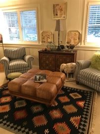 Striped upholstered chairs, Rattan weave ottoman, Great Navajo-inspired pattern newer rug.