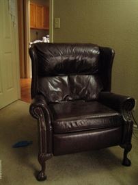 Leather wing back recliner with claw feet.