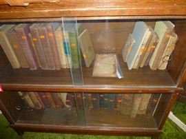 Vintage Books in glass front book shelf