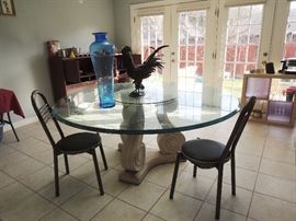 Huge, thick, round glass top table with base. 2 metal chairs