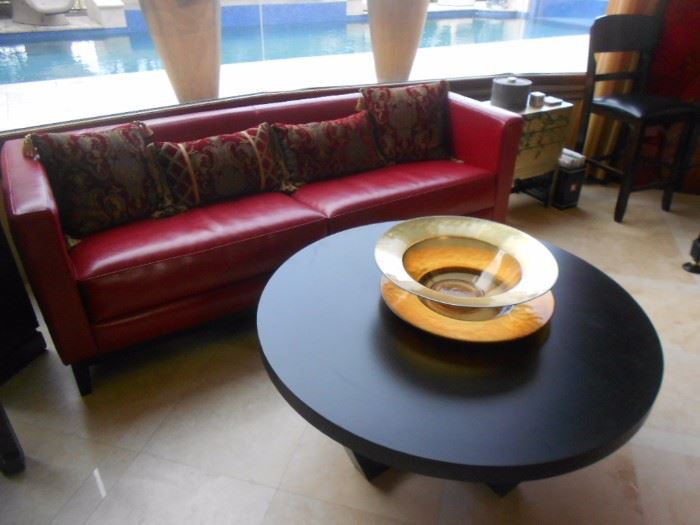 Red leather couch, very high end! Notice two cushions instead of three!  Coffee table, four leather circular low chairs that surround it, and two end tables.