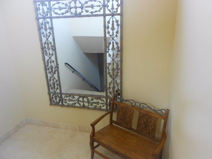Landing of one of the two stair cases.  This mirror is huge, with a wonderful metal design of foliage. Bench for 2.