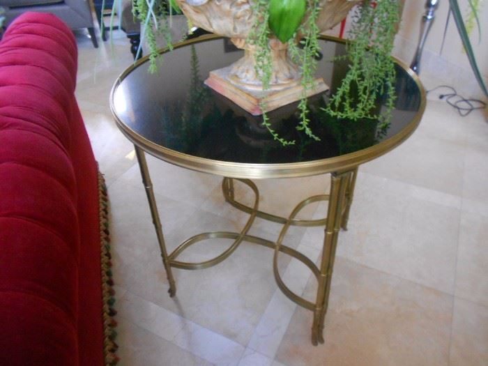 Stunning end / occasional table. Polished gold with black glass.