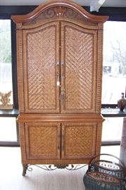 Exceptionally nice rattan entertainment center with iron decorative base