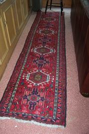 One of a PAIR of handmade oriental rugs - they measure 10' by 2' 5"