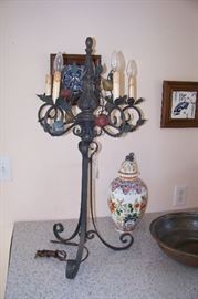 One of a pair of iron lamps with fruit