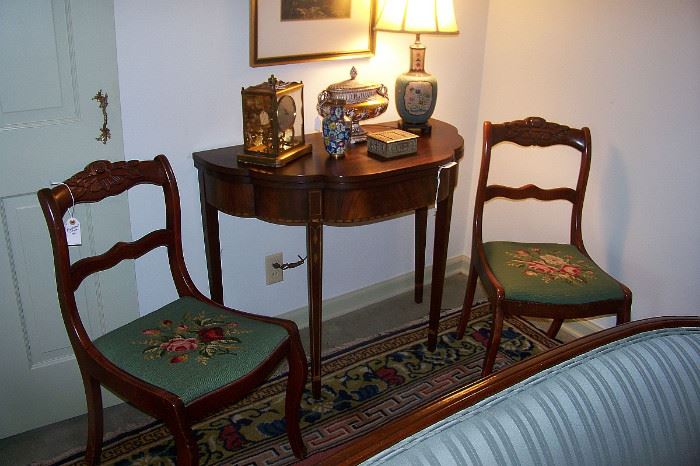 Henkel Harris card table in mahogany.  There are 4 of the needlepoint chairs