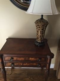 End table and tan lamp with black leaf design