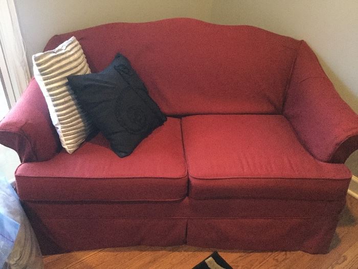 Love seat with red slip cover