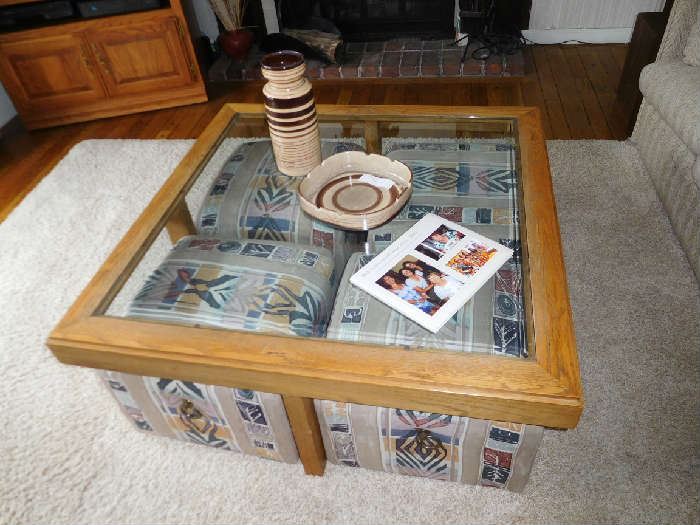 large  coffee  table  with  4  hassocks   that  go  with  it