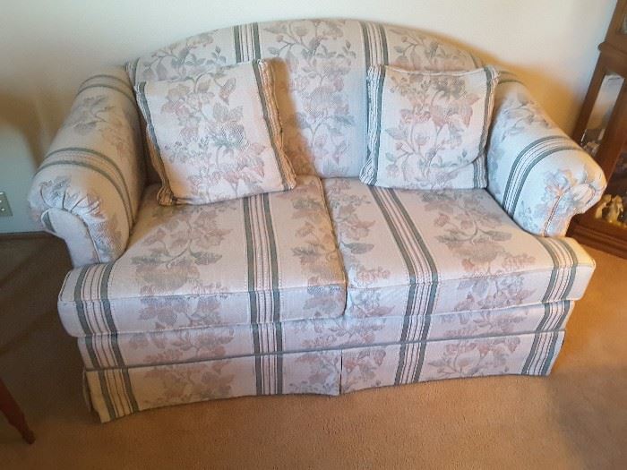 2 Seater Flowered Couch with matching pillows.