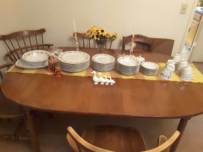Dining room table has one leaf, thReed cover pads, China dinner set, small collectibles. Ladder back chairs five.