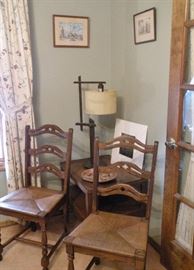 Caned seat chairs. Mid-century end table. Arts and Crafts style lamp. 