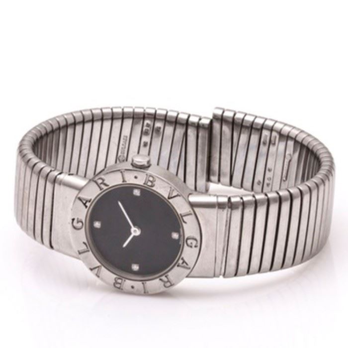 Bvlgari Diamond Accent Wristwatch: A Bvlgari stainless steel diamond accent wristwatch. This watch features a black dial with diamond indexes at the 12, 9, 6, and 3 o’clock positions. It is marked “Bvulgari” to the bezel. It has a highly polished flexible cuff with rectangular links.
