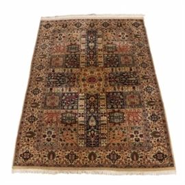 Handwoven Wool Bakhtiari Area Rug: A hand loomed Bakhtiari area rug in wool. This Persian rug features a curvilinear central medallion and four rectangular panels creating a cruciform shape over the field. The field’s remaining quadrants contain classic Bakhtiari square panels, which are populated with detailed tree of life forms and medallions. Amid the palette of taupe, cornsilk, tea, crimson, olive, celadon, salmon, and navy, the rug includes two guard borders and a main border with palmettes, stylized trees of life, and eight-pointed star medallions. There is fringe at north and south. The rug is unmarked.