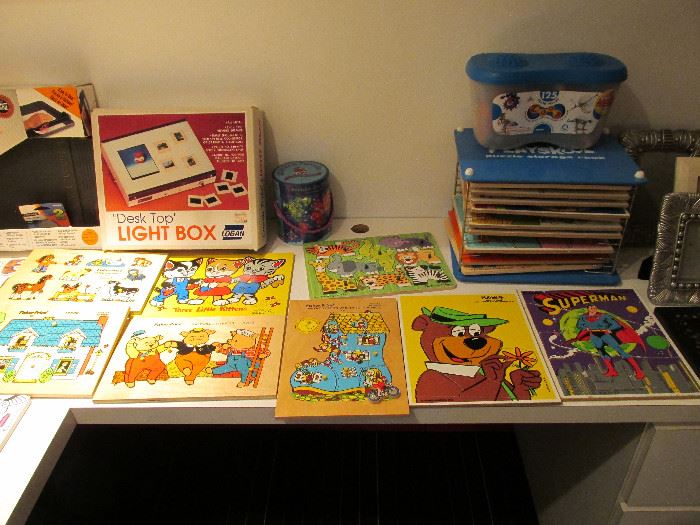 Many wooden children's puzzles.