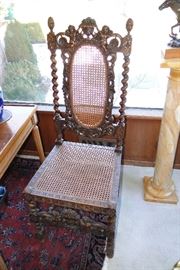 There is a pair of these carved chairs