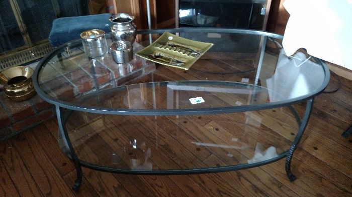 Coffee table with brushed nickle frame with 2 pieces of oval glass shelves