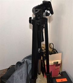 Lot 19: Lot includes Tasco binoculars, tripod with case, Polaroid camera, movie light
