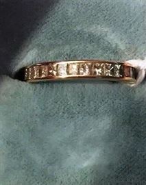 LOT 46: 14K Yellow gold eternity band, containing 31 princess cut diamonds channel set, weighing 1.50 carat total weight, diamonds are white in color and "VS" clarity.  Ring size 5.
