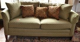 Lot 59: Stickley two cushion sofa in olive green with diamond pattern upholstery with two cushion back; 30"h x 70"w x 36"d (comes with throw pillows) (30)
