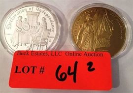 Lot 64: 2 American Mint Medals - "John Hancock Declaration of Independence" with gold enhanced signature and "We the People".  Silver plated over copper.  Both encased in plastic.
