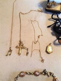 Lot 62: Lot of jewelry: unmarked locket, unmarked etched cross with 2 necklaces (marked 14k) and musical note pendant (mark illegible), GF cameo bracelet
