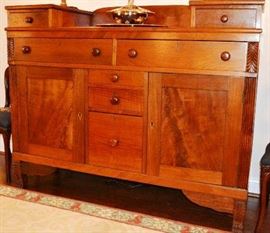 Lot 100: "Walnut Empire sideboard with raised gallery drawers and drop center, fluted and acanthus carved columns and raised on carved paw feet.  Lower section consists of 2 long drawers.  Yellow pine secondary.  Probably NC in origin.  Ca. 1820.  21""d x 50 1/2""h, 63""l (35)
"
