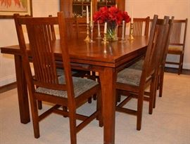 Lot 101: "Stickley Cherry Mission style dining extension table with 2  draw leaves and exposed butterfly joints on table top, together with 8 Mission style ladder-back chairs (chairs labeled ""L.J.G. Stickley"", table branded ""Stickley"".  All in excellent condition.  30""h x 42""d x 72""l (each leaf 24""), chairs
41""h x 19"" seat height x 17 1/2"" seat width (4)"
