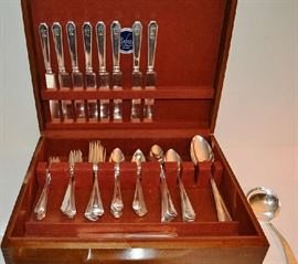 Lot 117: Sterling silver flatware: "Queen Anne Plain" by Domink & Haff, 76 pieces, some monogrammed"C or R" some plain.  8 bolster blade knives (8.5"l), master butter knife, 8 salad forks, 8 dinner forks, 8 citrus spoons, 8 teaspoons, 8 ice tea spoons, 2 serving spoons, 1 sugar shell spoon, 1 carving set, 4 tablespoons, 1 gravy ladle, 8 oyster forks, 8 butters.  In silver box.  58.92 toz. (excludes knives) 
